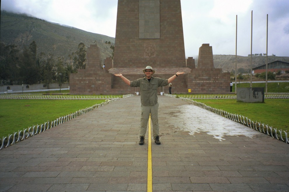 The goofball shot of the tourist standing with one foot on either side of the equator.