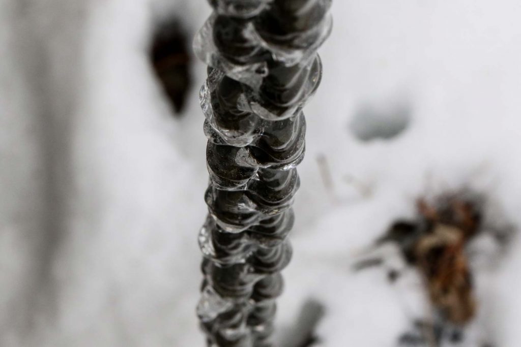 Looking down a chain encased in ice